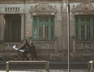 man riding n bike near building painting thumbnail