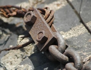 macro shot of gray steel  chain with bolt and stud thumbnail