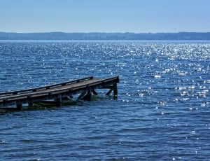 brown wooden dock surrounded by body of water during daytime thumbnail
