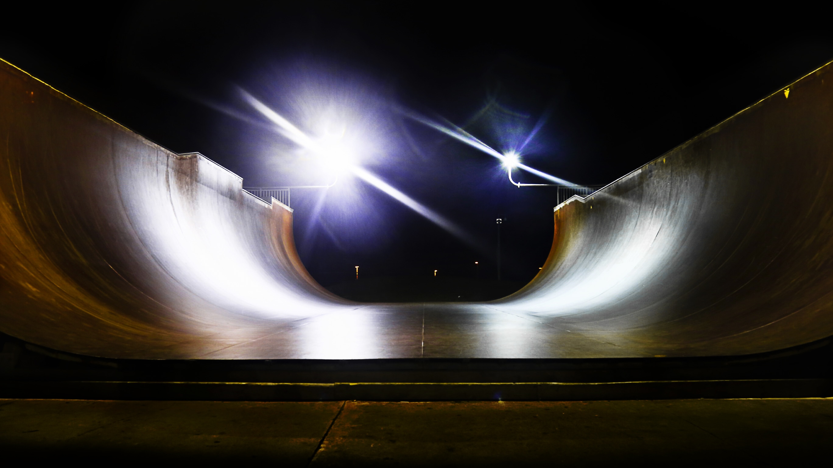 skateboard robb field beside light posts during nighttime