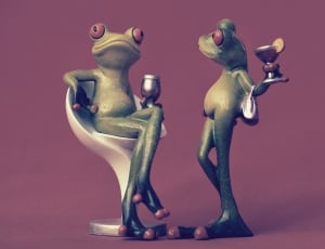 two green tree frogs holding a drinking glasses figurines thumbnail