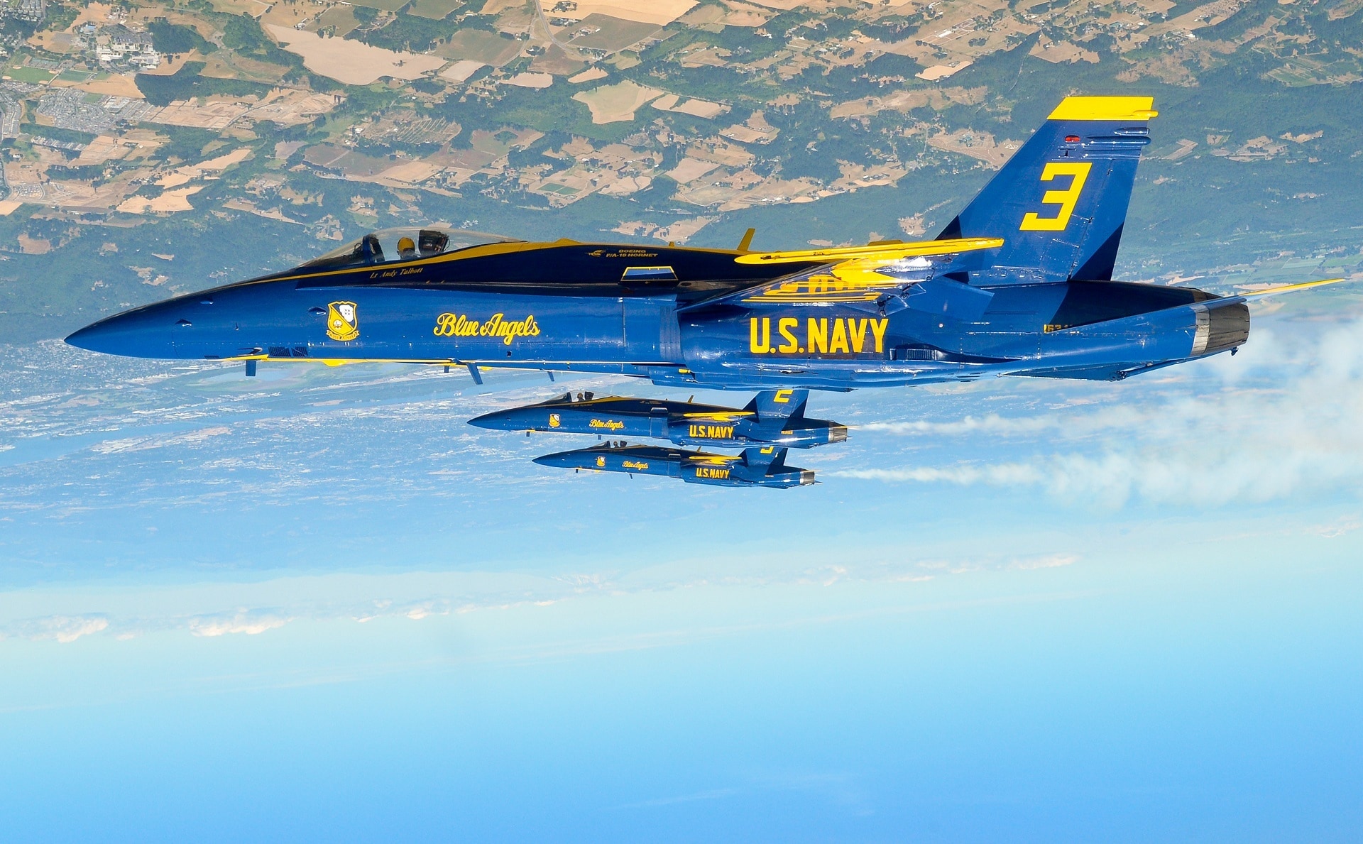 blue and yellow U.S. Navy plane