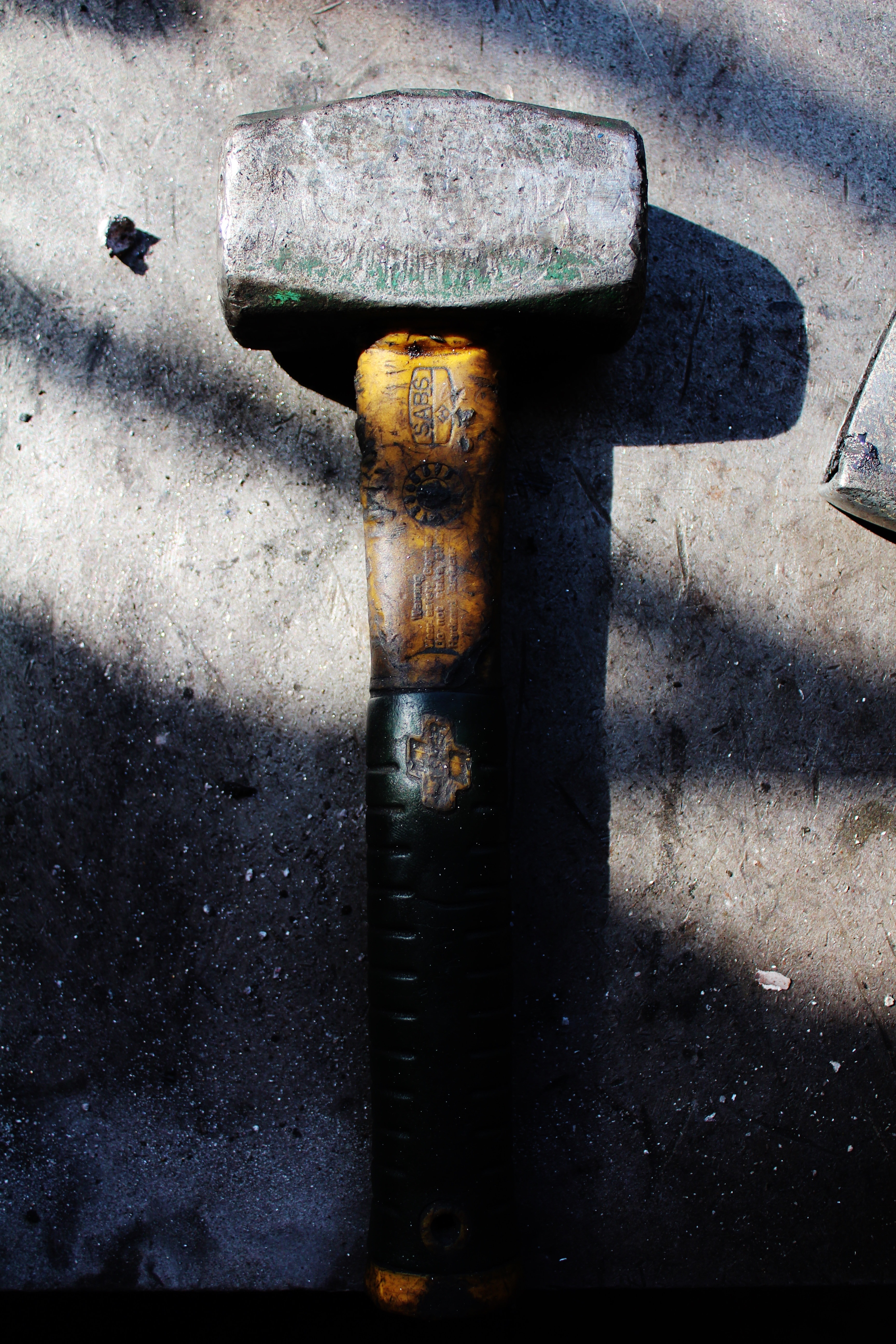 grey and yellow sledge hammer